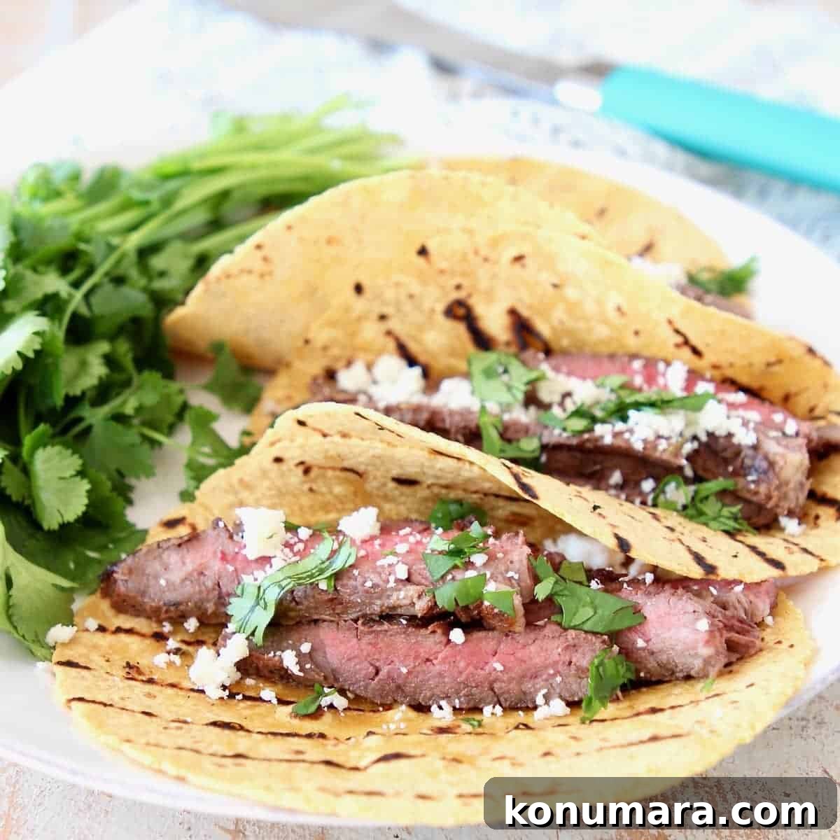 Sliced Cajun Marinated Grilled Skirt Steak in Grilled Corn Tortillas with Cotija Cheese and Fresh Cilantro