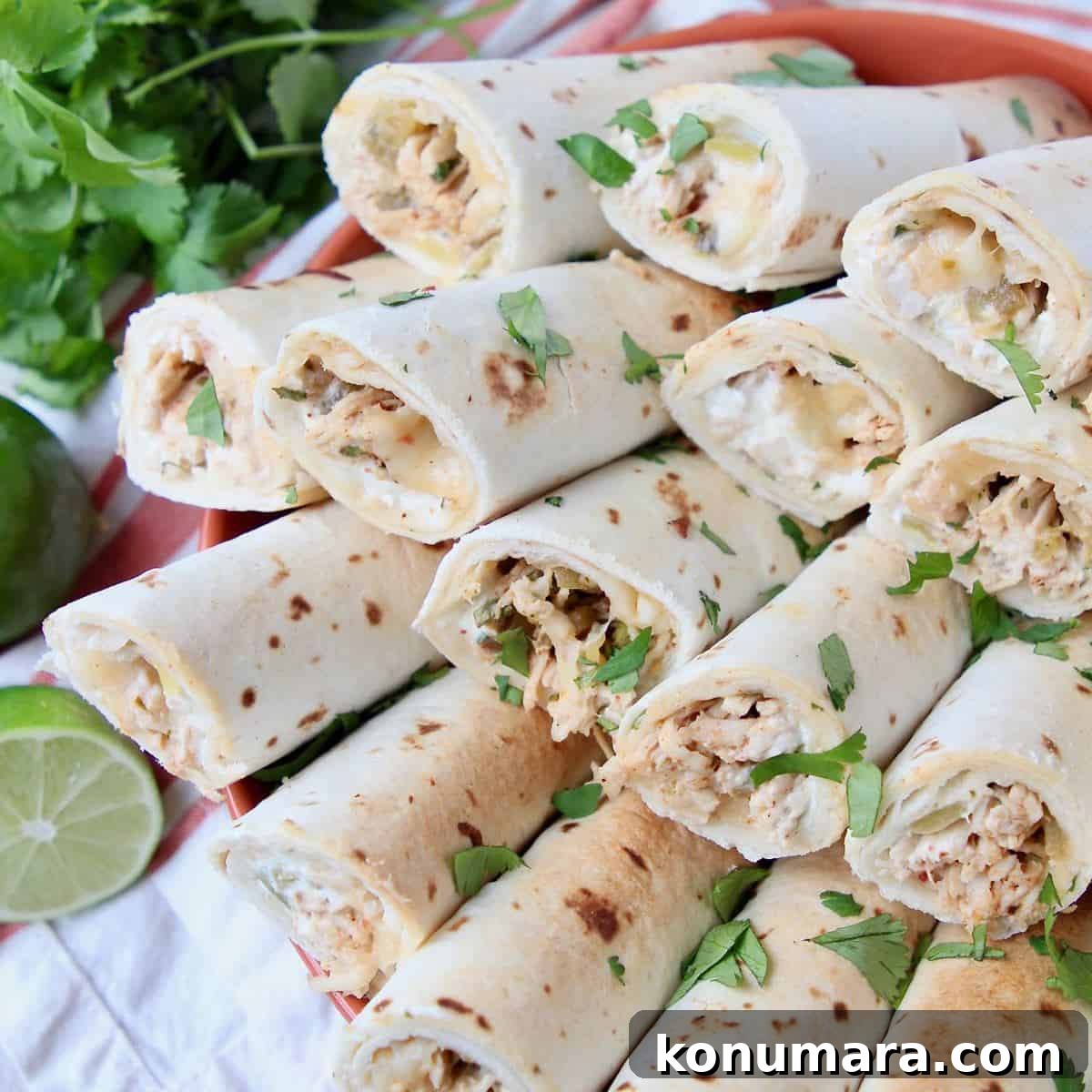 Rolled tacos sliced in half on top of each other in orange bowl
