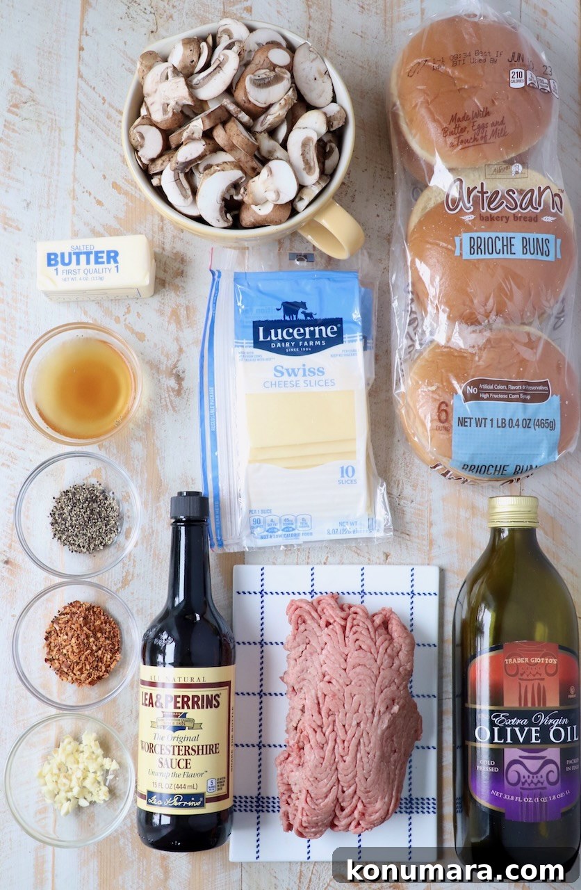 Ingredients for mushroom swiss burgers on wood board