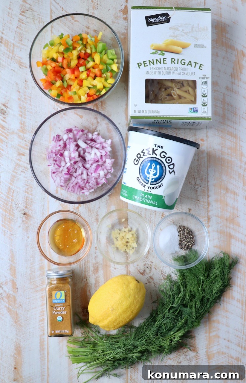 ingredients for pasta salad on white wood board