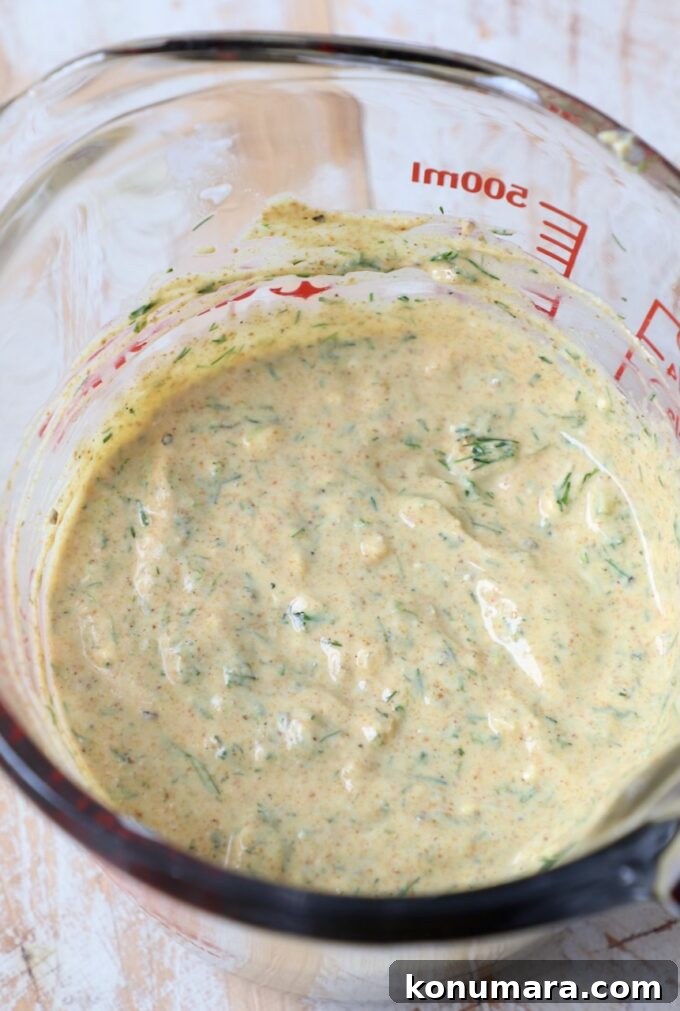 curry dill greek yogurt salad dressing in glass bowl
