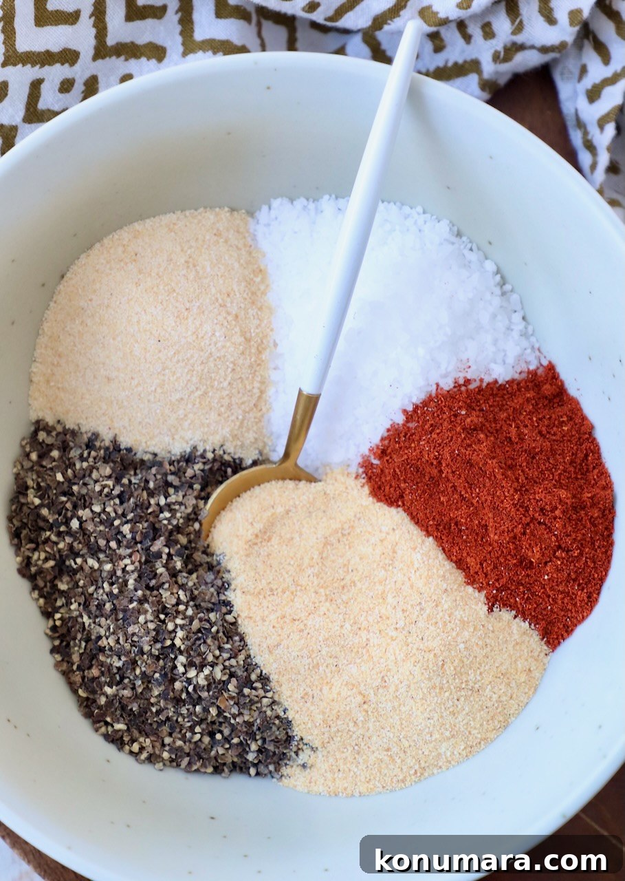 Homemade Pulled Pork Rub for Smoky BBQ 2 spices separated in bowl with spoon