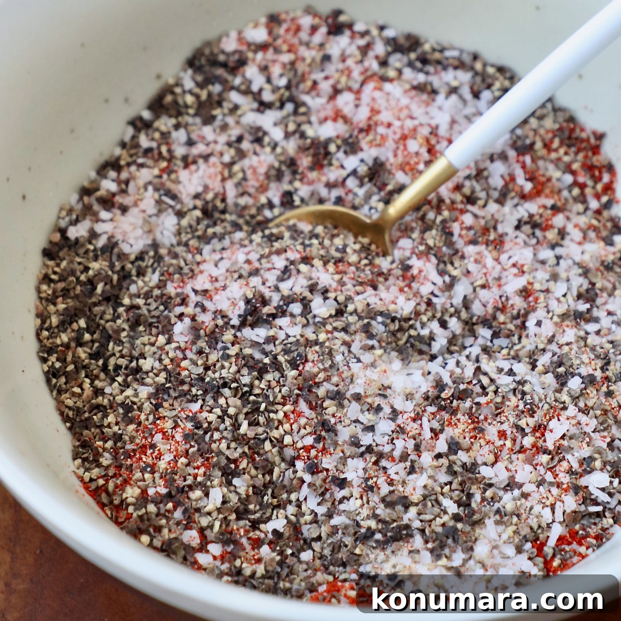 Homemade Pulled Pork Rub for Smoky BBQ 5 spices mixed together in bowl with spoon
