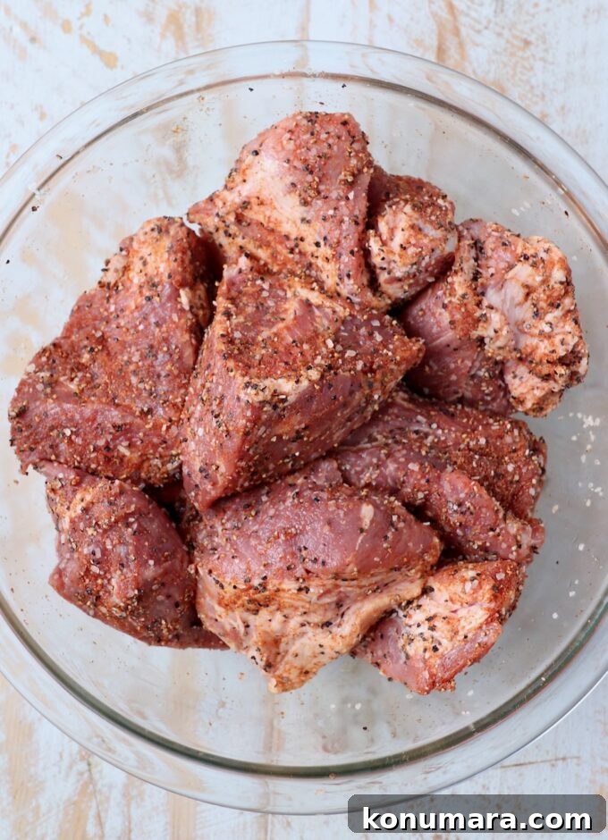 Tender and Juicy Instant Pot Pulled Pork Recipe 4 large pieces of pork shoulder seasoned in large glass bowl