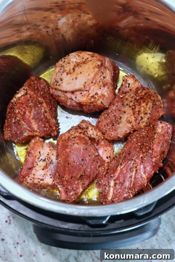Tender and Juicy Instant Pot Pulled Pork Recipe 5 large pieces of seasoned pork in olive oil in Instant Pot