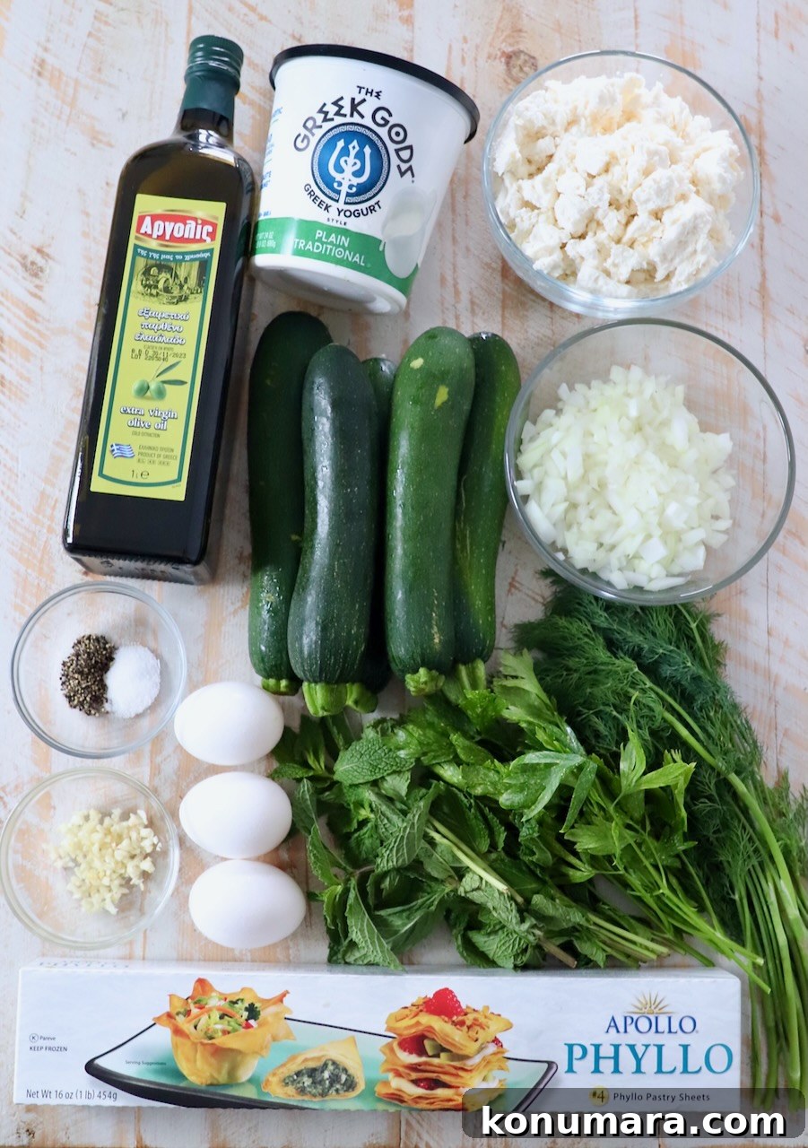 ingredients for Greek zucchini pie on white wood board
