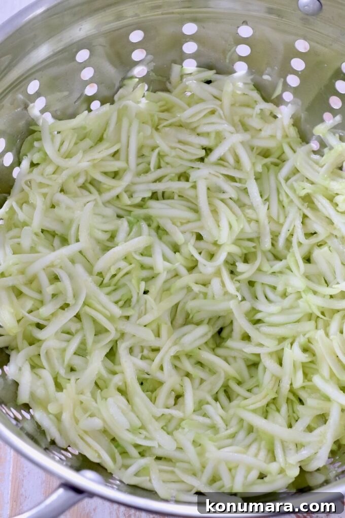 grated zucchini in colander