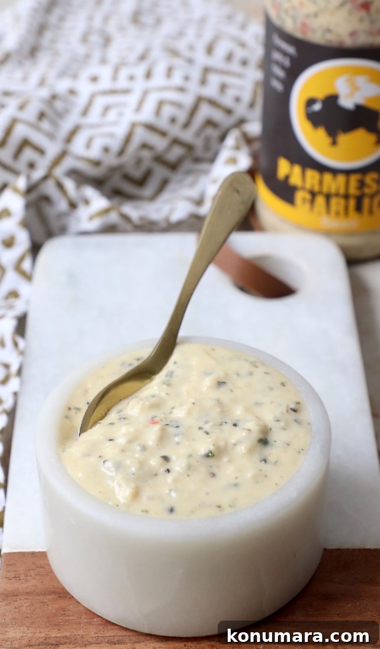 Creamy Garlic Parmesan Sauce Recipe 6 garlic parmesan sauce in small bowl with spoon