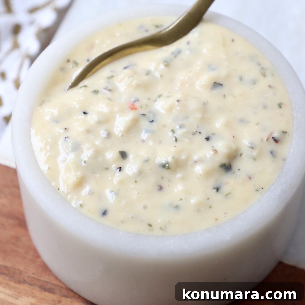 Creamy Garlic Parmesan Sauce Recipe 8 garlic parmesan sauce in small bowl with spoon