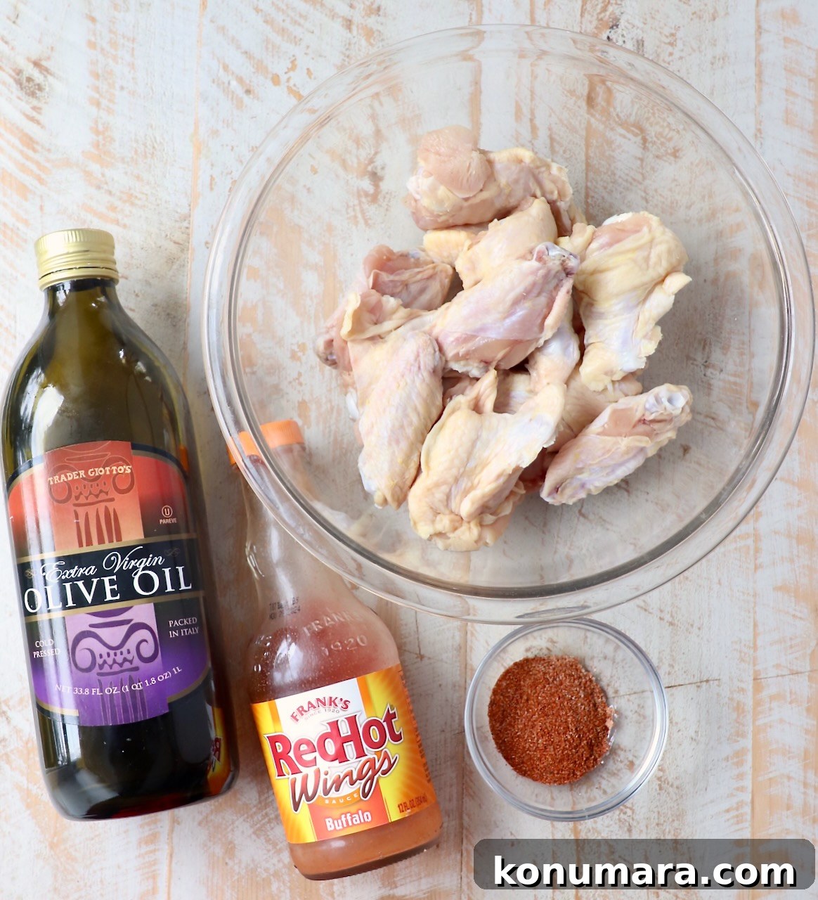 ingredients for grilled chicken wings on white wood board