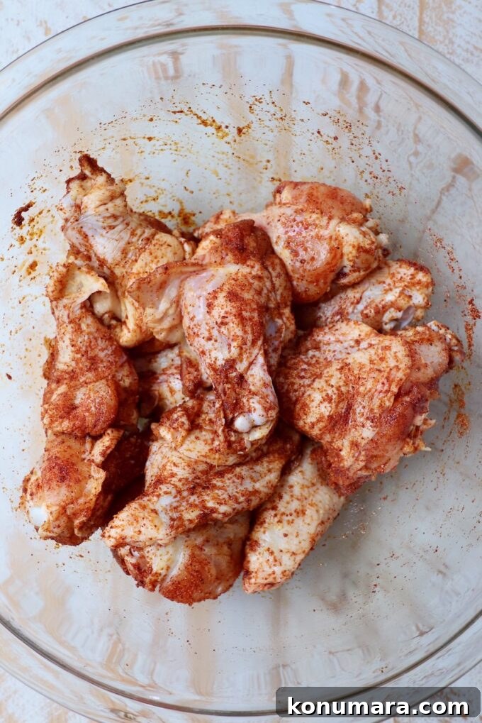 seasoned chicken wings in glass bowl
