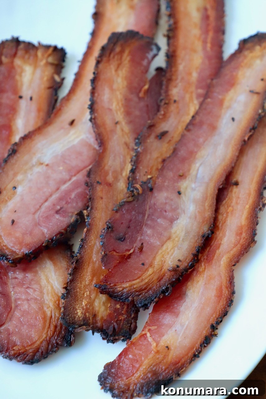 cooked, sliced bacon on white plate