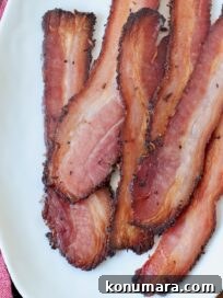 cooked slices of bacon on white plate