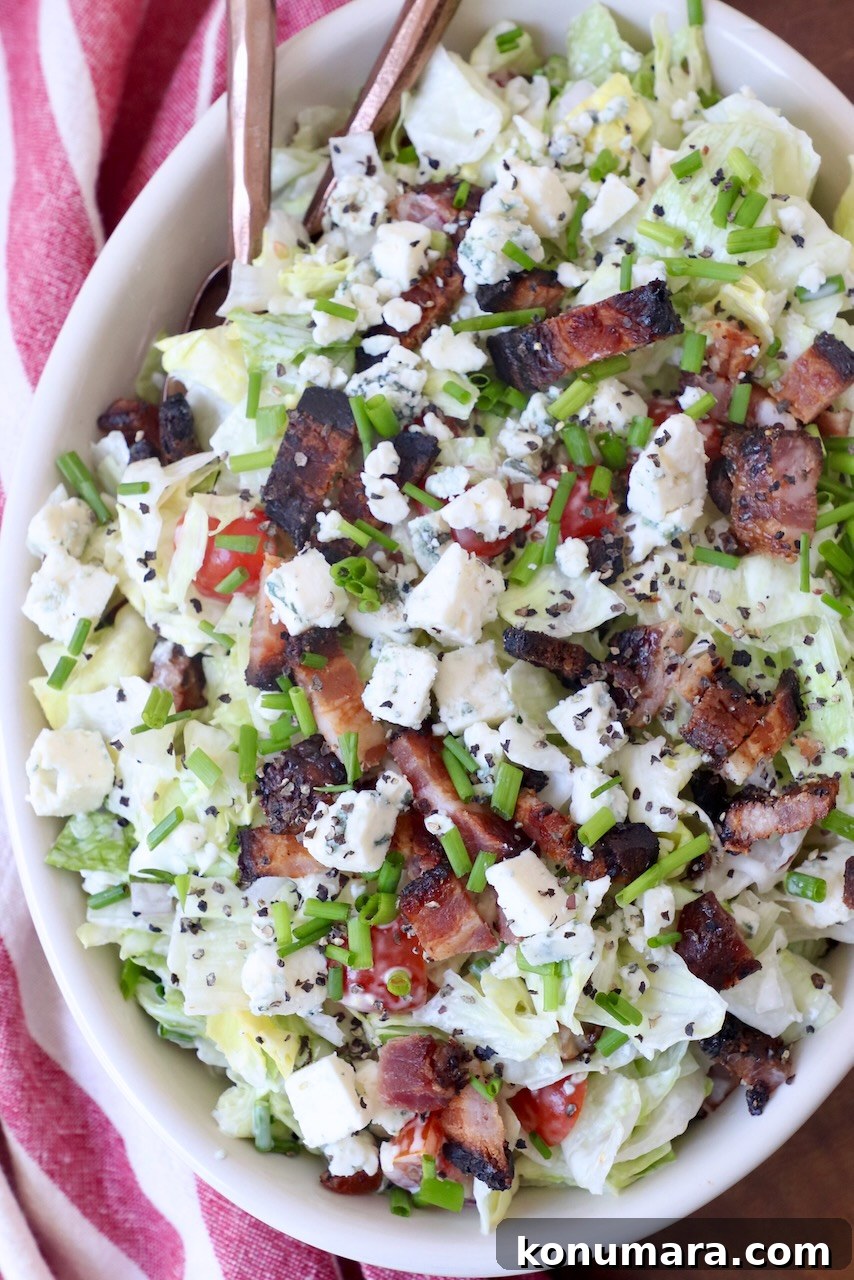 Creamy Blue Cheese Salad Recipe with Tangy Dressing 4 chopped salad in bowl topped with bacon and blue cheese