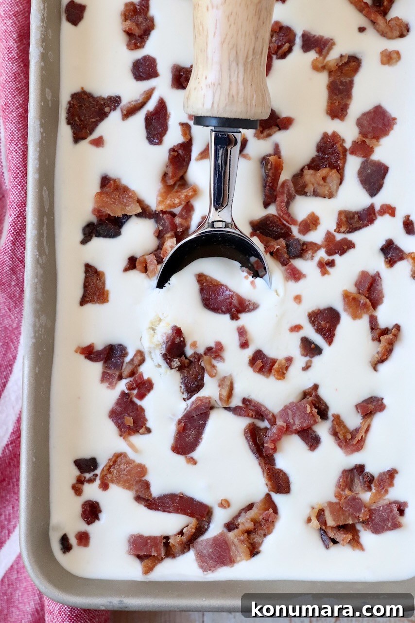maple bacon ice cream in metal container with ice cream scoop