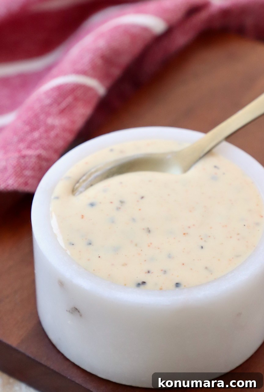 Creamy Alabama White BBQ Sauce Recipe 2 white bbq sauce in small white bowl with spoon