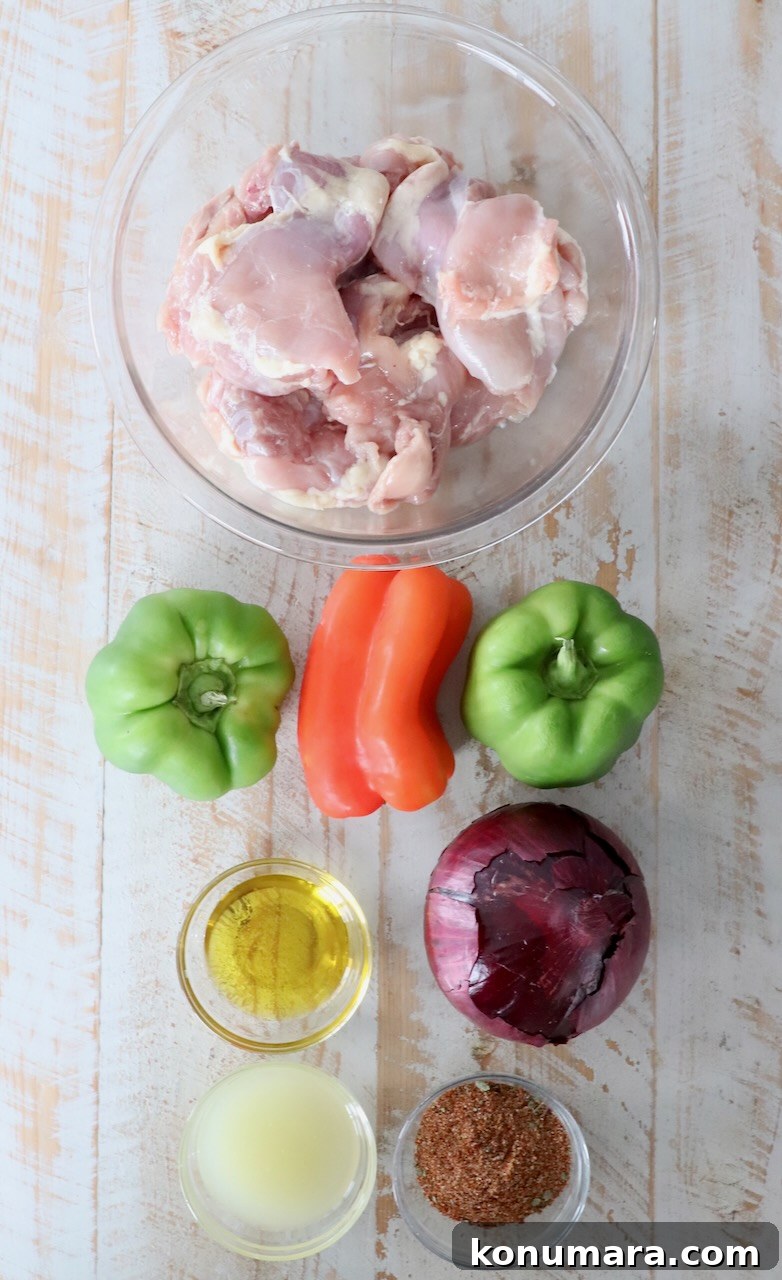 ingredients for chicken fajitas on white wood board