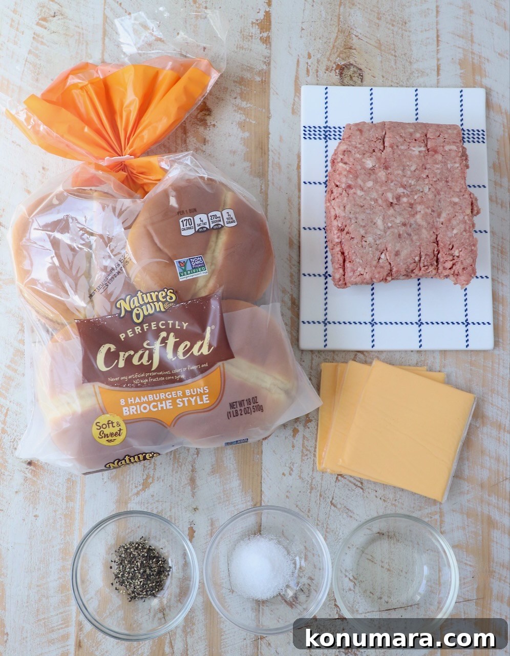 ingredients for smash burgers on white wood board