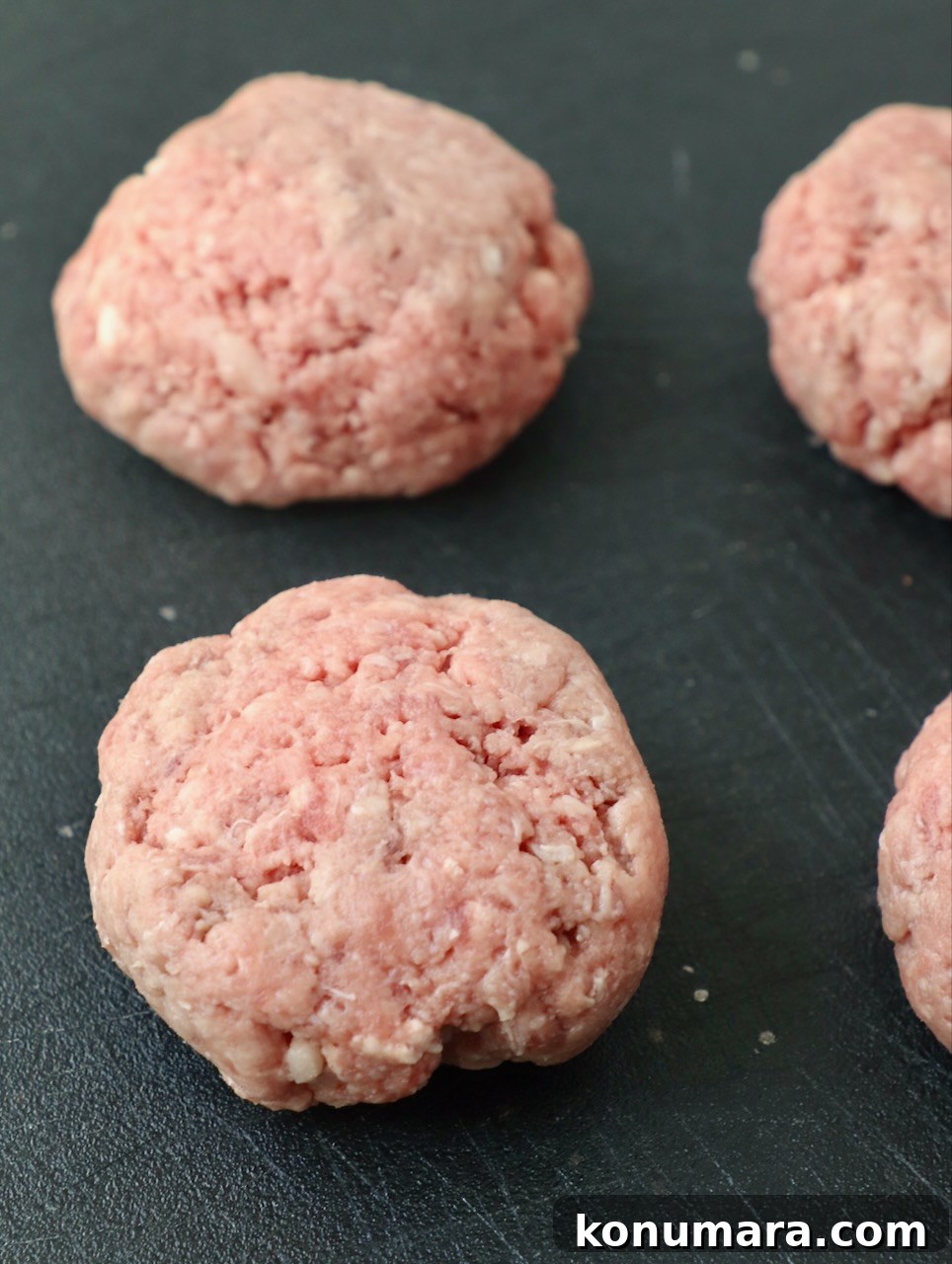 balls of ground beef on cutting board