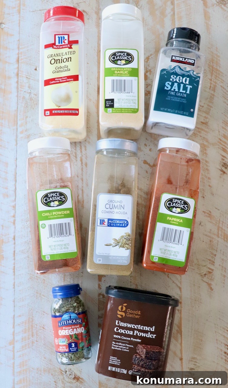 spices in plastic containers on white wood board