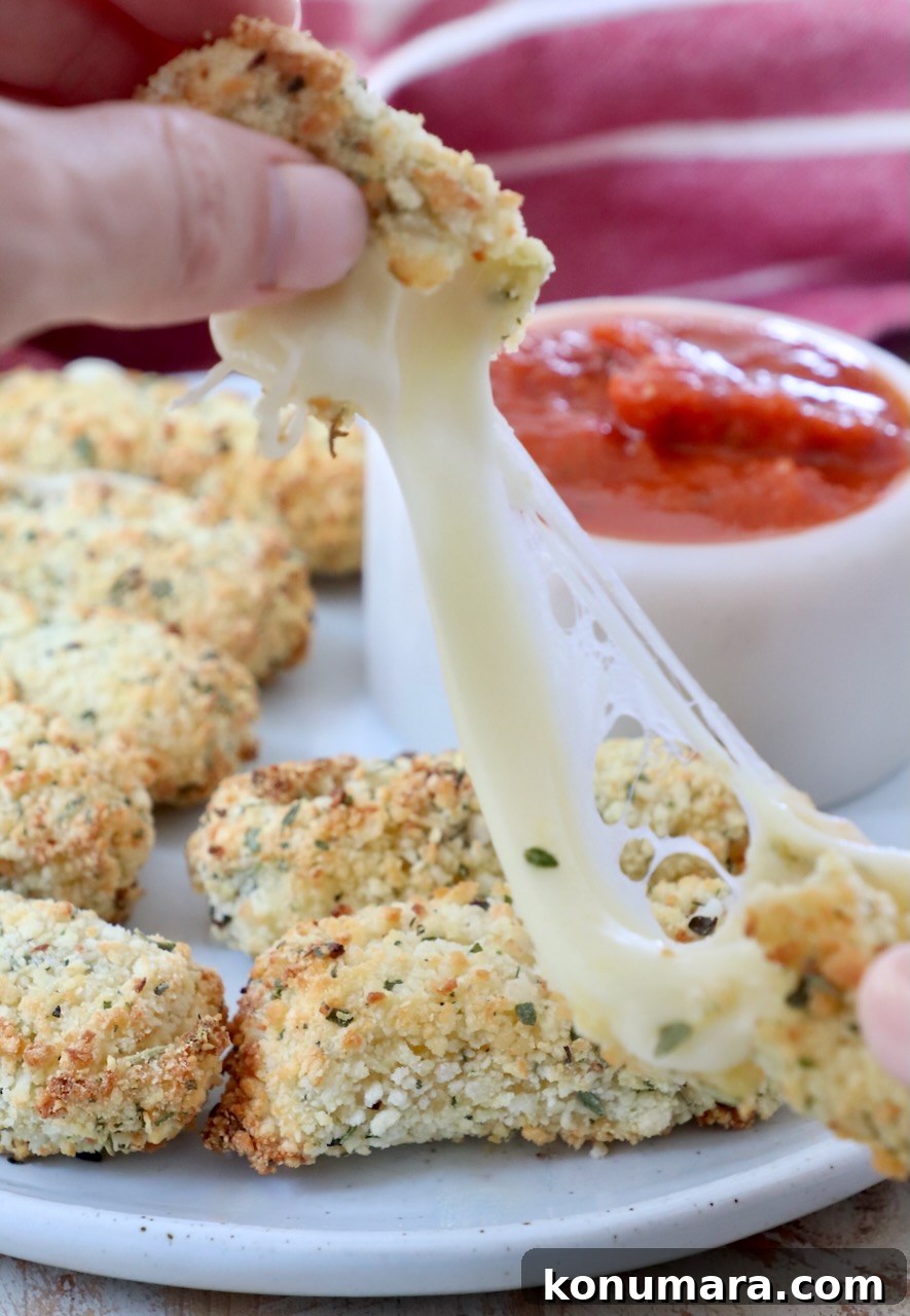 mozzarella stick pulled apart with hands