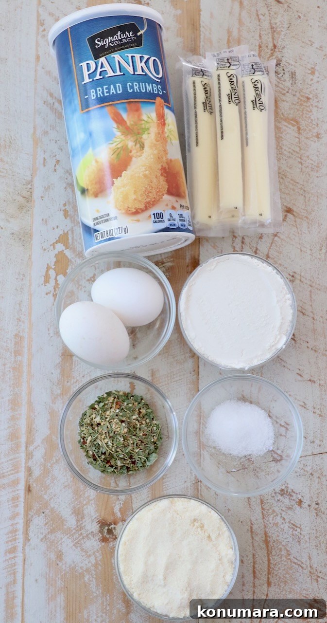 ingredients for mozzarella sticks on white wood board