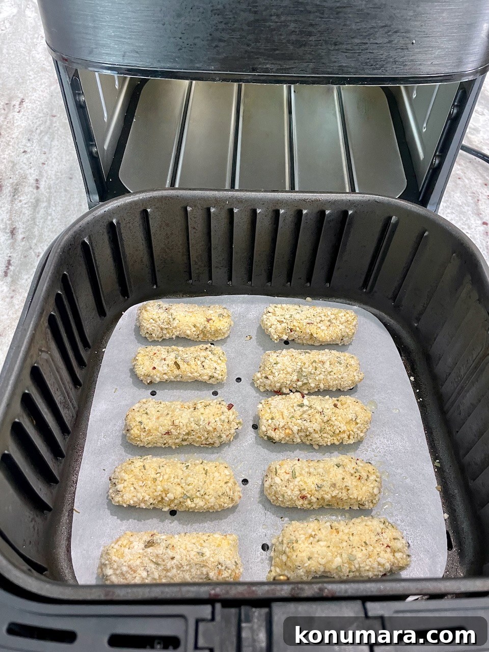 breaded mozzarella sticks in air fryer basket