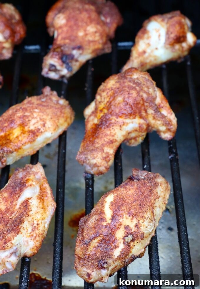 Smoked Chicken Wings: Crispy, Tender and Flavorful 7 cooked, seasoned chicken wings on smoker