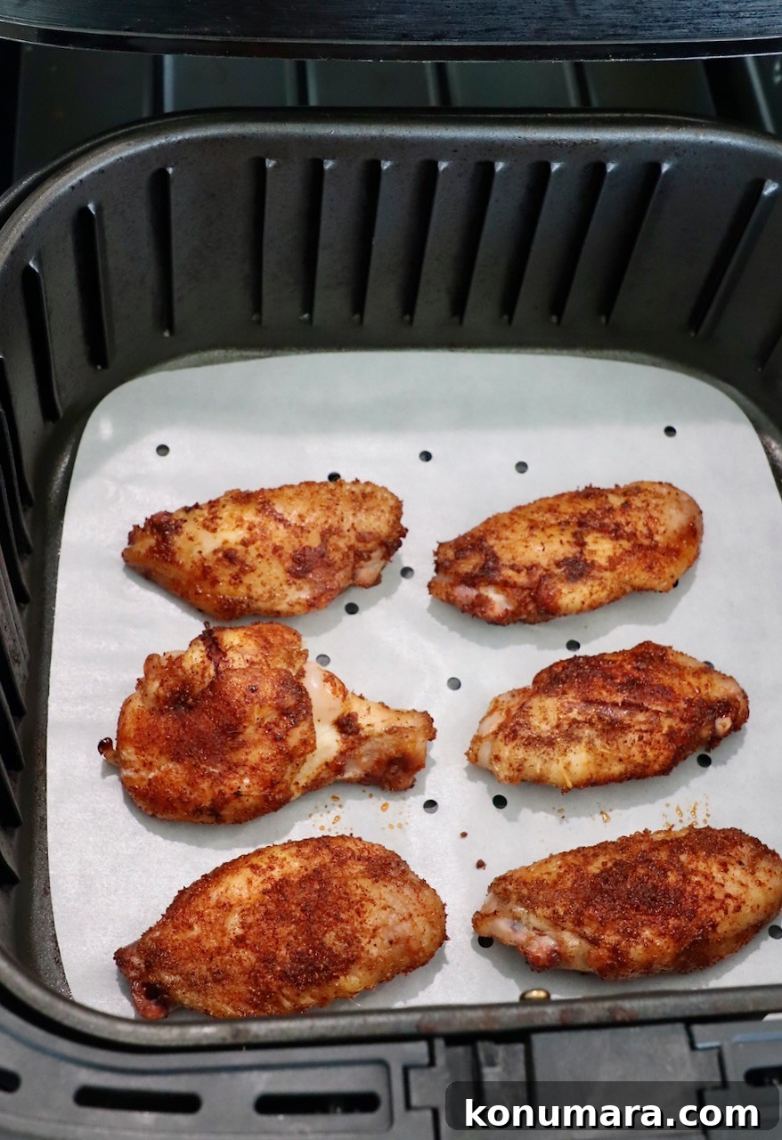 Smoked Chicken Wings: Crispy, Tender and Flavorful 8 seasoned, smoked chicken wings in air fryer basket
