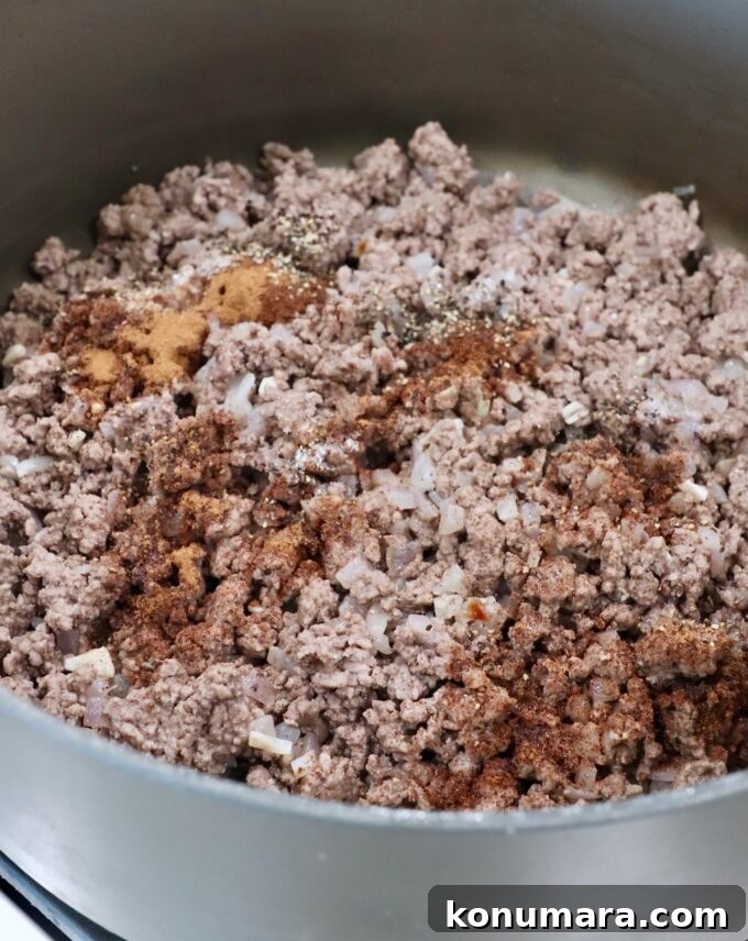 seasoned, cooked ground beef in large skillet