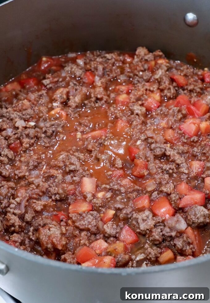 cooked ground beef tomato sauce in large skillet