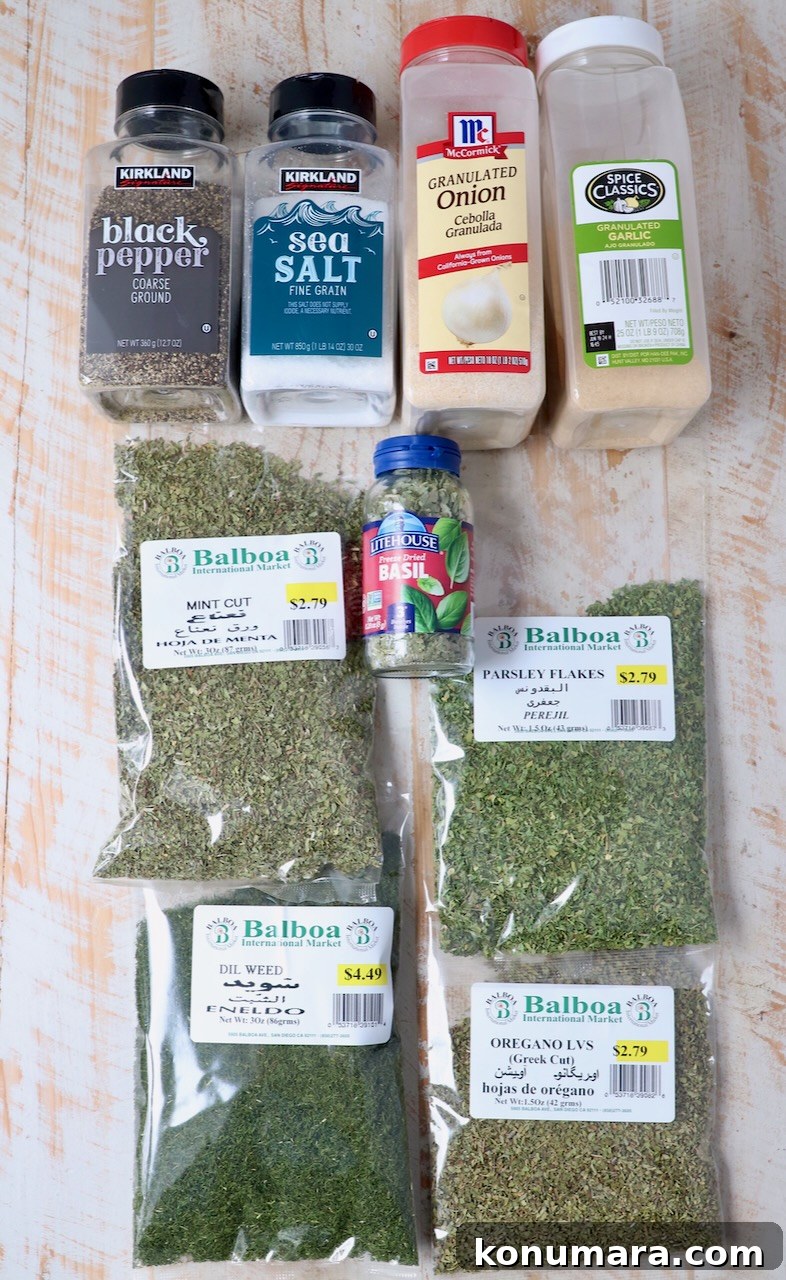 ingredients for Greek seasoning on white wood board