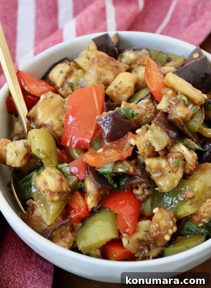 marinated eggplant salad in bowl with spoon