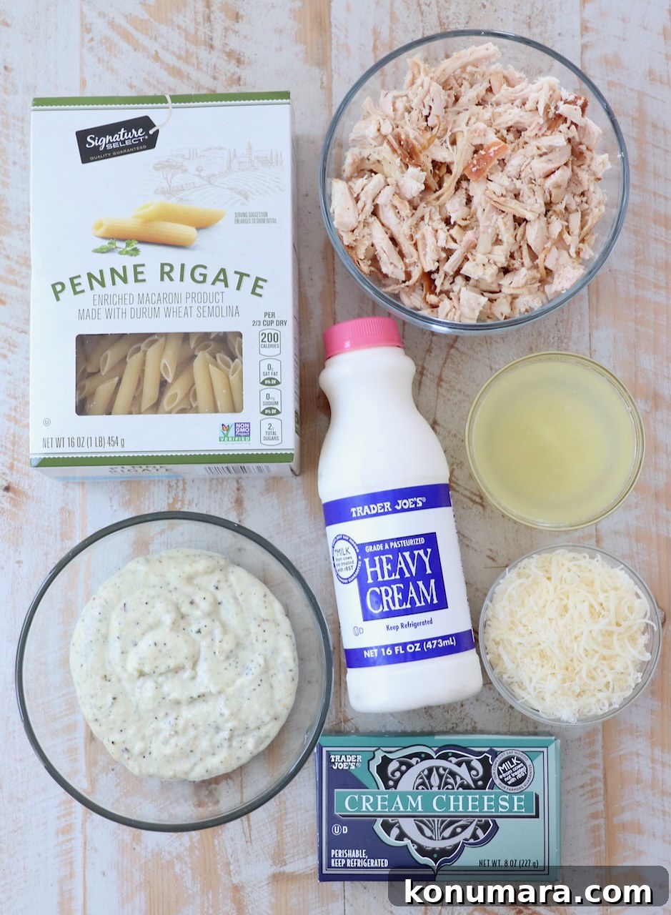 Creamy Garlic Parmesan Chicken Pasta Recipe 3 ingredients for garlic parmesan chicken pasta on white wood board