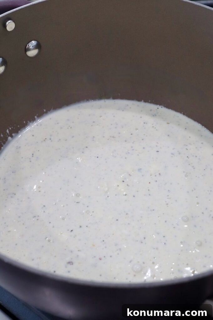 Creamy Garlic Parmesan Chicken Pasta Recipe 4 garlic parmesan white sauce in saucepan