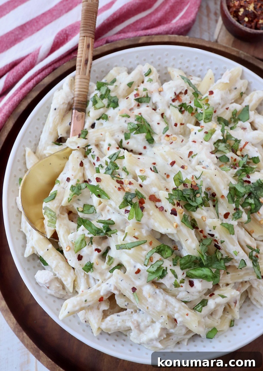 Creamy Garlic Parmesan Chicken Pasta Recipe 8 cooked garlic parmesan chicken pasta in bowl topped with chopped green onions
