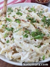 Creamy Garlic Parmesan Chicken Pasta Recipe 10 garlic parmesan chicken pasta in bowl with serving spoon