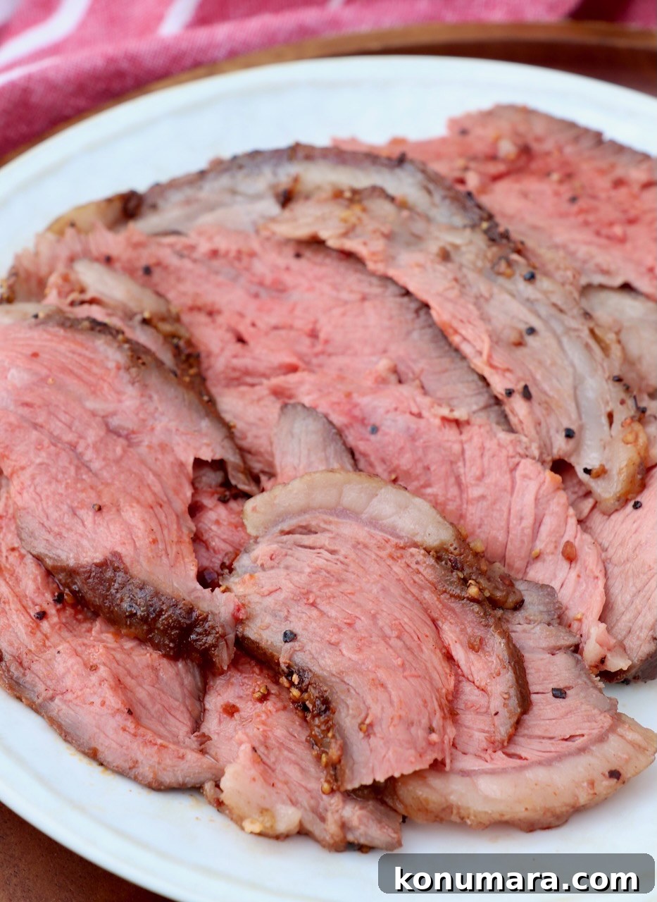 Rotisserie Picanha Recipe: Juicy Brazilian Rump Cap on the Spit 11 thin slices of cooked steak on plate