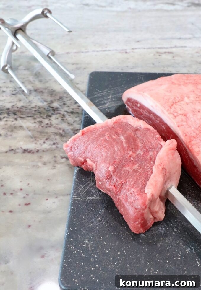 Rotisserie Picanha Recipe: Juicy Brazilian Rump Cap on the Spit 5 piece of steak on a rotisserie rod