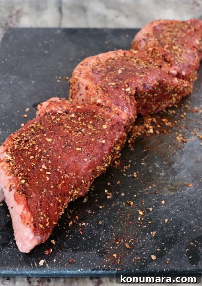 Rotisserie Picanha Recipe: Juicy Brazilian Rump Cap on the Spit 7 seasoned pieces of uncooked steak on a cutting board