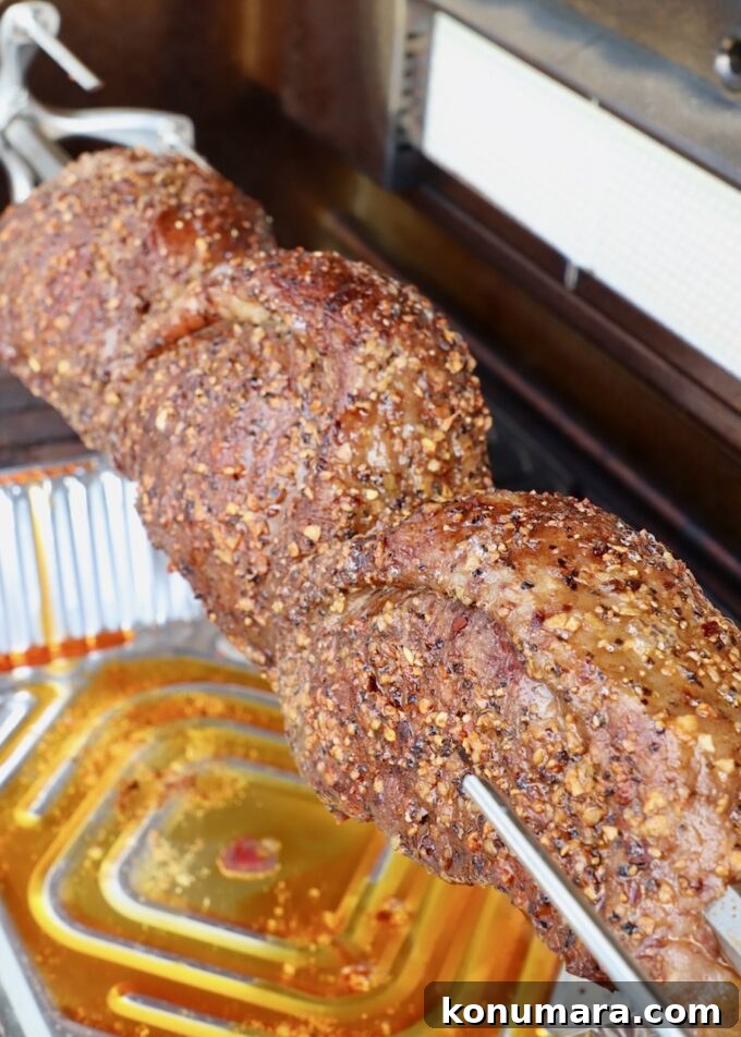 Rotisserie Picanha Recipe: Juicy Brazilian Rump Cap on the Spit 9 cooked steaks on a rotisserie rod in a grill