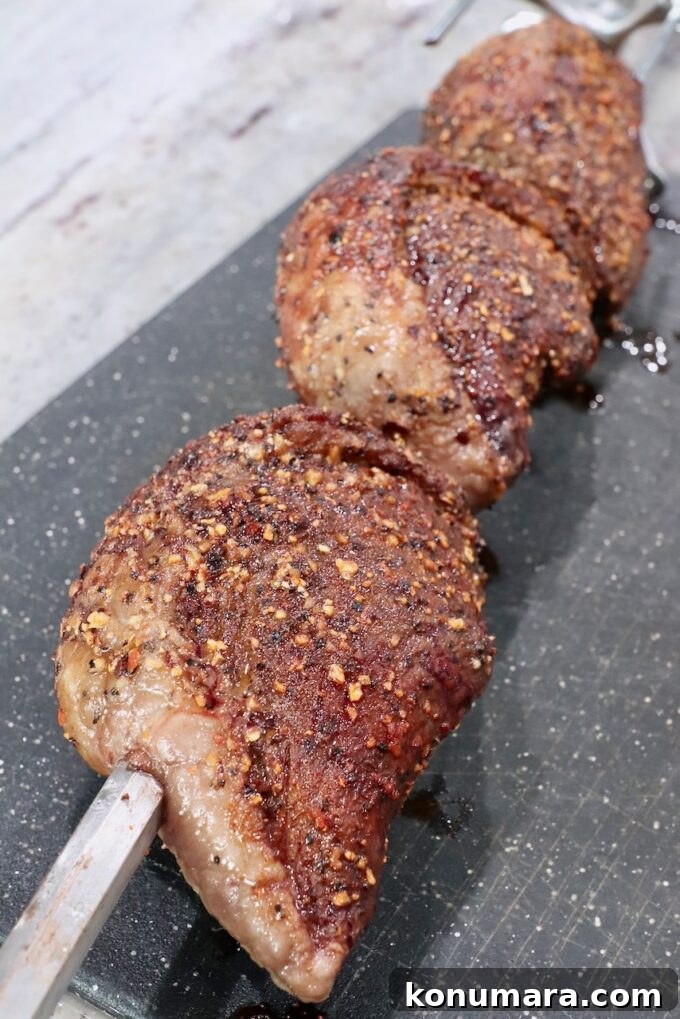 Rotisserie Picanha Recipe: Juicy Brazilian Rump Cap on the Spit 10 cooked steaks on rotisserie rod