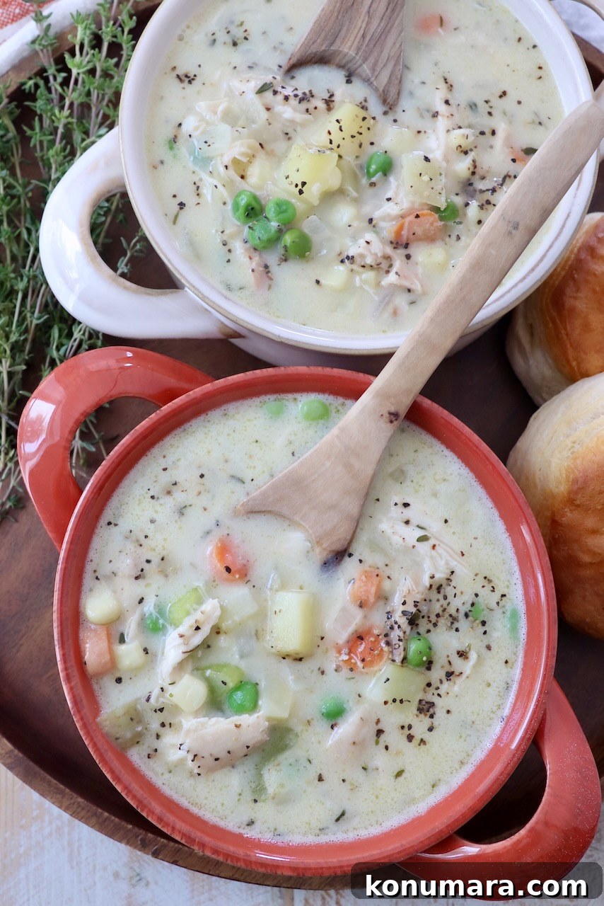 chicken pot pie soup in bowls with spoons