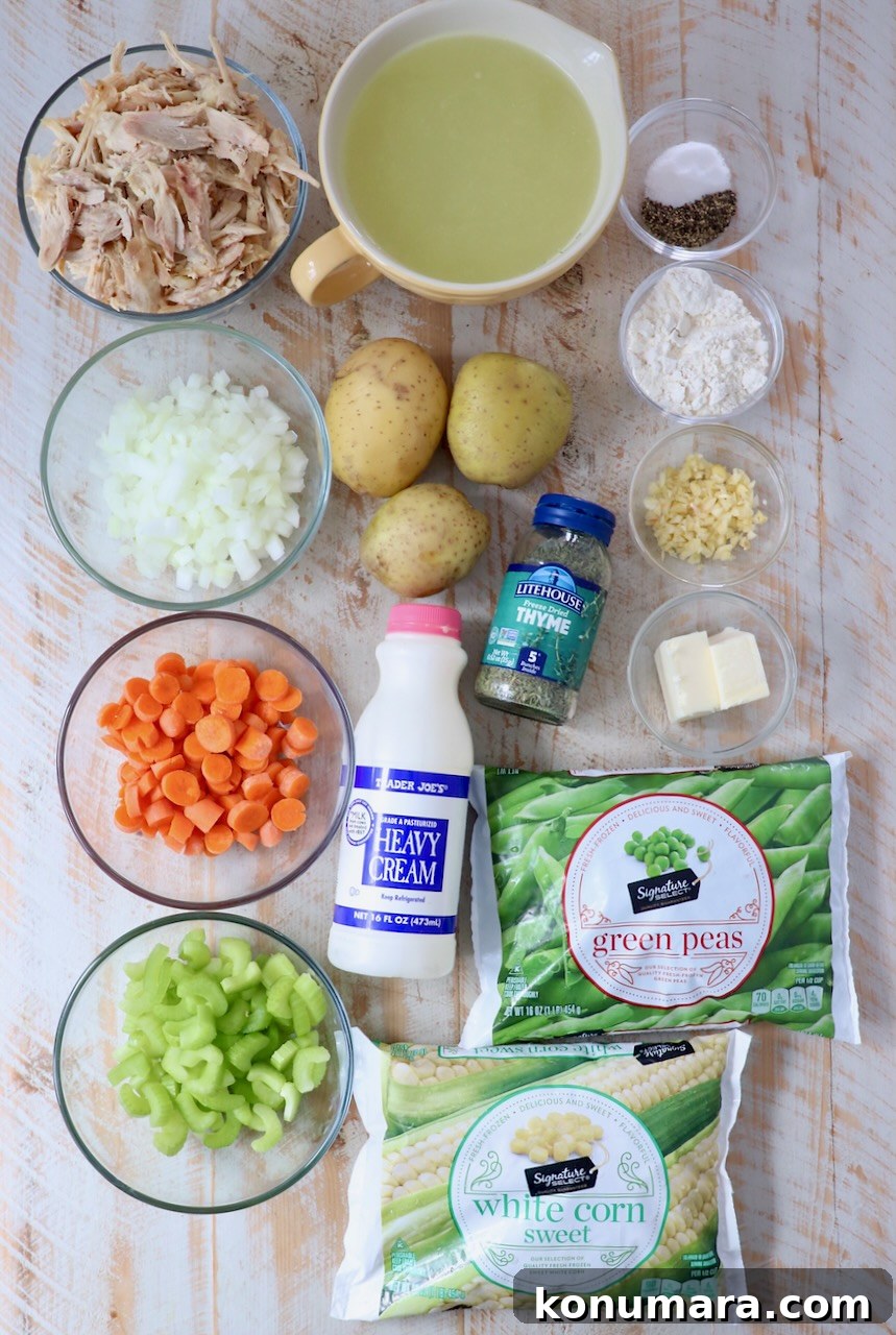 ingredients for chicken pot pie soup on white wood board
