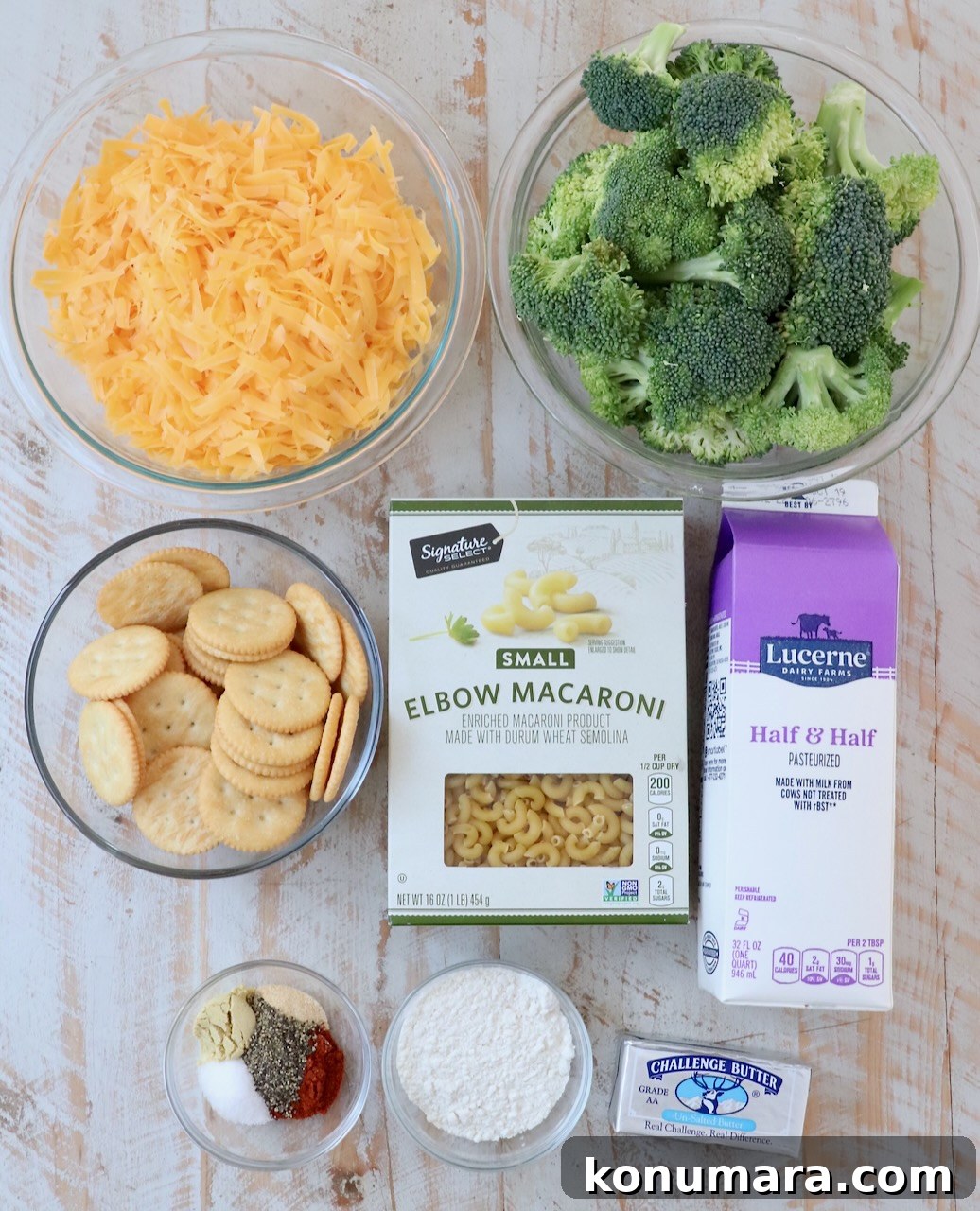 ingredients for broccoli mac and cheese on white wood board