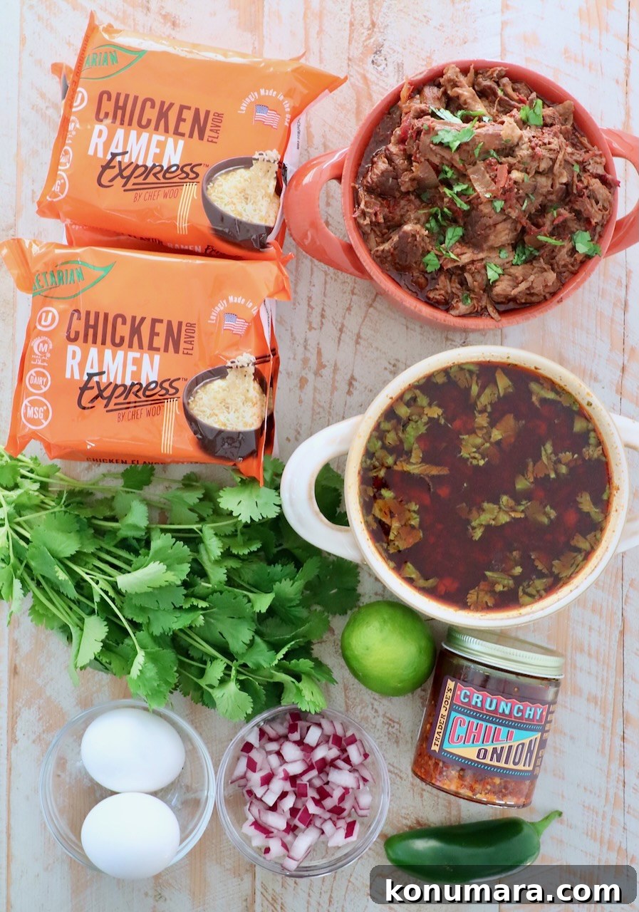 ingredients for birria ramen on white wood board