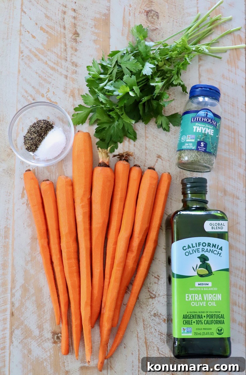 Oven-Roasted Carrots with Honey and Garlic 3 ingredients for roasted carrots on white wood board
