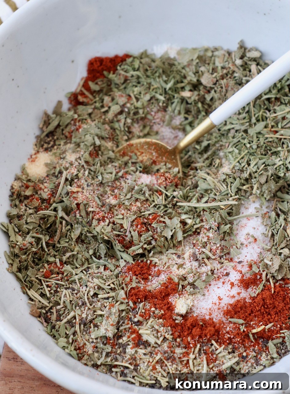 herbs and spices mixed together in bowl with a spoon