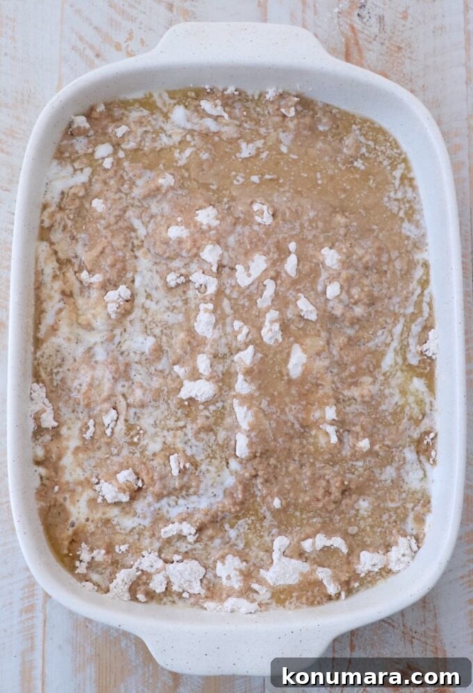 One-Pan Caramel Apple Dump Cake Recipe 6 cake mix covered in melted butter in baking dish