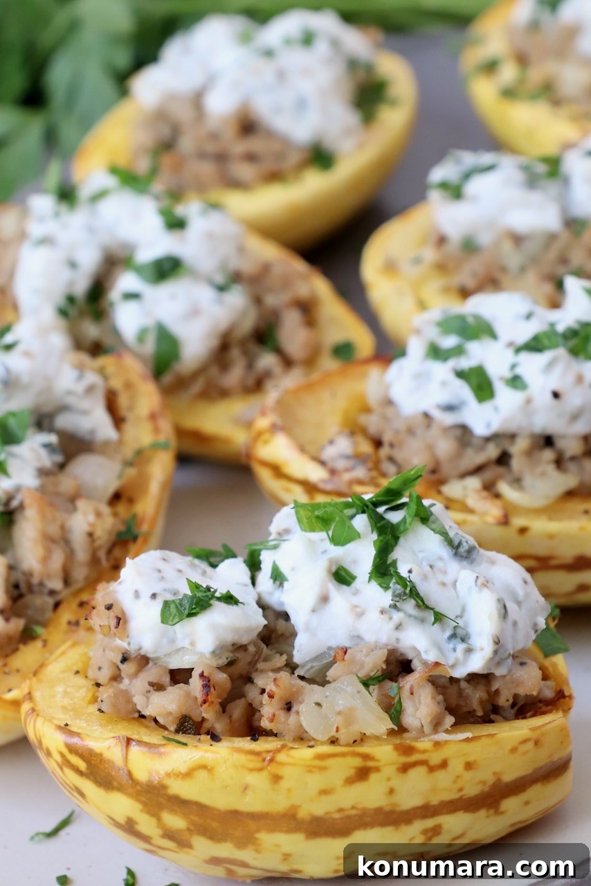 How to Cook Delicata Squash: Roast, Bake and Saute 12 roasted delicata squash cut in half stuffed with ground chicken sausage and ricotta cheese on plate
